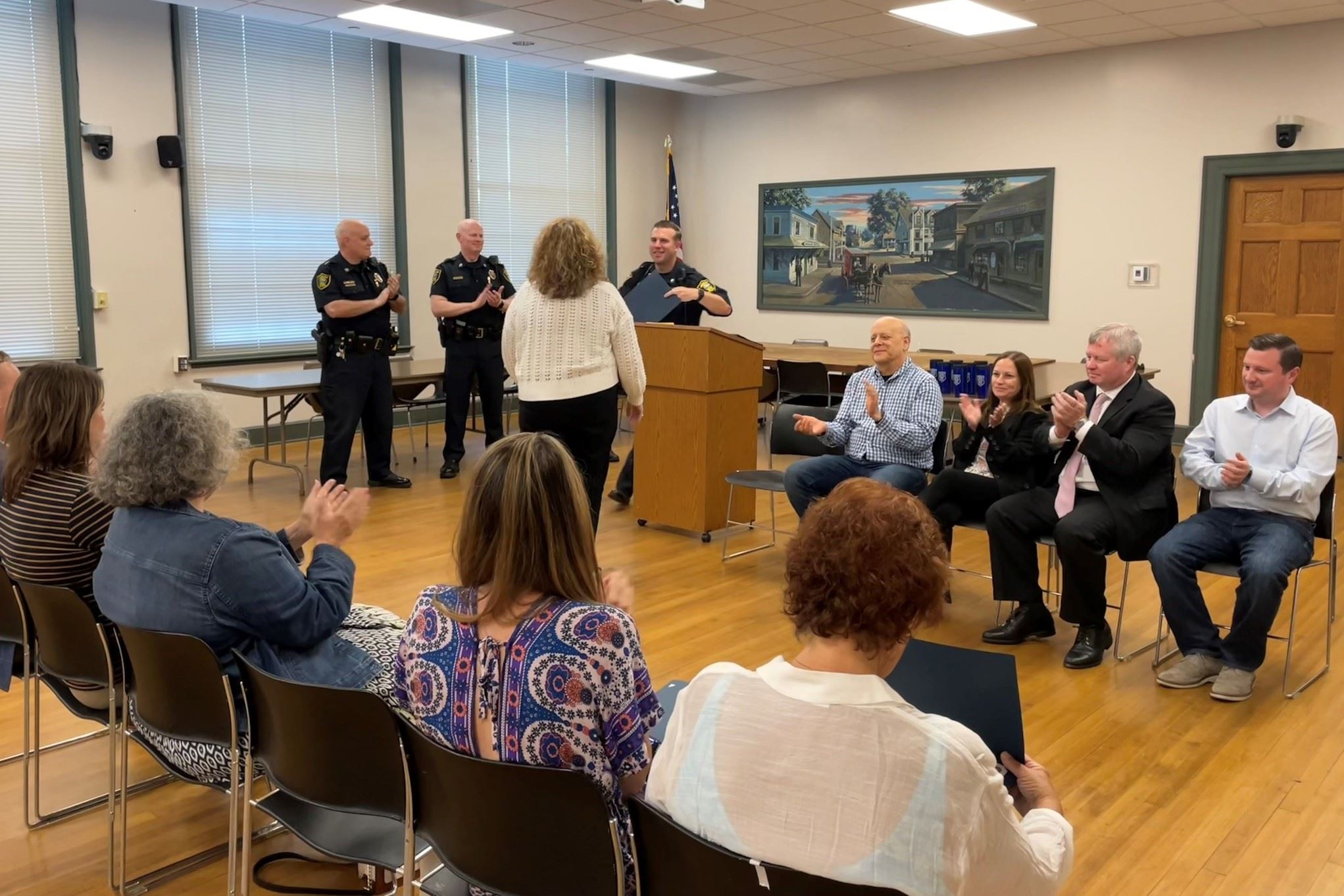 People in meeting room clapping